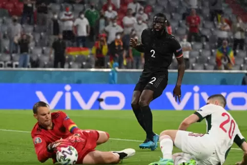 Deutschlands Torhüter Manuel Neuer (l) fängt den Ball neben Ungarns Roland Sallai. Mitte ist Deutschlands Antonio Rüdiger.