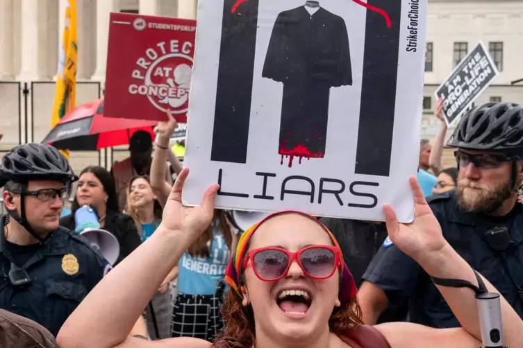 „Lügner“ steht auf dem Plakat, das eine Frau in den Händen hält, die gegen die Aufhebung des liberalen Abtreibungsrechts demonst