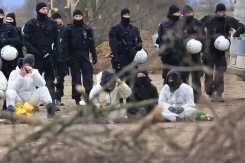 Klimaschutzaktivisten und Polizisten am Rand des nicht mehr bewohnten Dorfes Lützerath. Das Dorf soll zur Erweiterung des Braunk