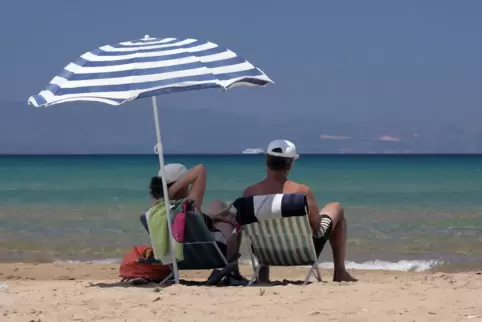Urlaub am Strand unterm Sonnenschirm: Griechenland ist in diesem Sommer ein gefragtes Urlaubsziel. 