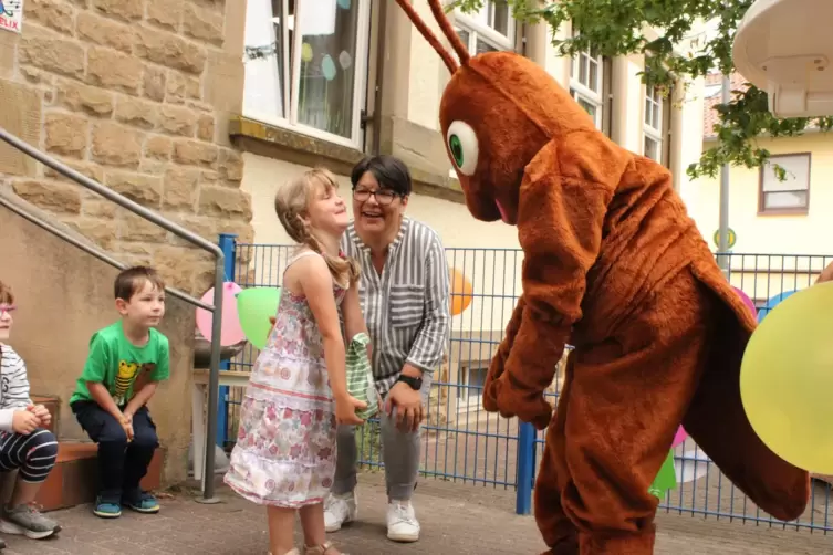 Namensgeberin Klara John bekommt ein Geschenk von Maskottchen „Ella-Bella“. Kita-Leiterin Charlotte Angné (Mitte) freut sich mit