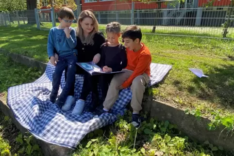 Nora Liebel mag die Arbeit mit Kindern – hier beim Vorlesen mit (von links) Jonas, Valentina und Cristian.