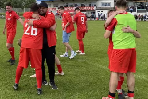 Erleichterung nach dem Sieg: Niederkirchens Trainer Sven Ohlinger (mit Kappe) umarmt einen Spieler nach dem anderen.