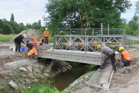 Die Arbeiten sind im Gange; im Hintergrund die temporäre THW-Brücke.