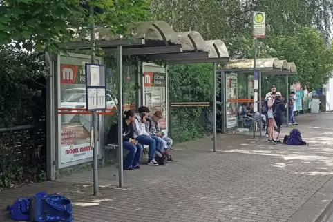 Jugendliche warten nach Schulschluss an der Haltestelle am Hofenfels-Gymnasium auf den Bus.