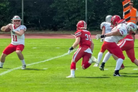 Pikes-Quarterback Janis Kaiser (links) ist im Heimspiel gegen die Marburg Mercenaries (in Rot) auf der Suche nach einer Anspiels