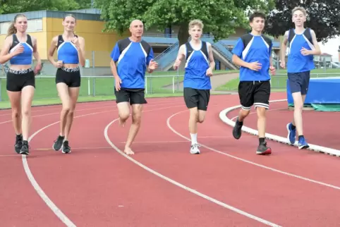Der barfuß laufende Trainer mit seinen Landesmeisterschaftsstartern: (von links) Mia Leiser, Sophie Meyer, Klaus Klein, Fredrik 