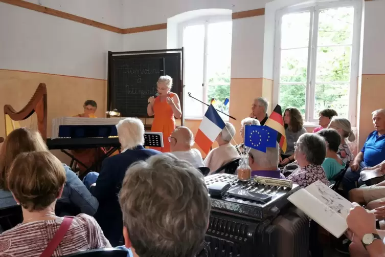 Wegen des Regens fand das Konzert in der alten Schule statt. Ein Teil der Besucher verfolgte es draußen unter Regenschirmen. 