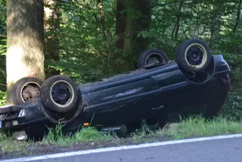 Das Auto hat sich überschlagen und ist vor einem Baum zum Liegen gekommen.