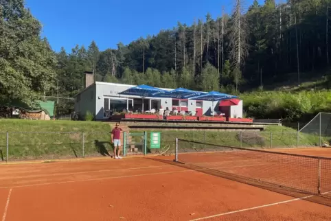 Tennisclub-Vorstand Uwe Schmidt am Rande eines der vier Tennisplätze. Im Hintergrund das Clubhaus. 