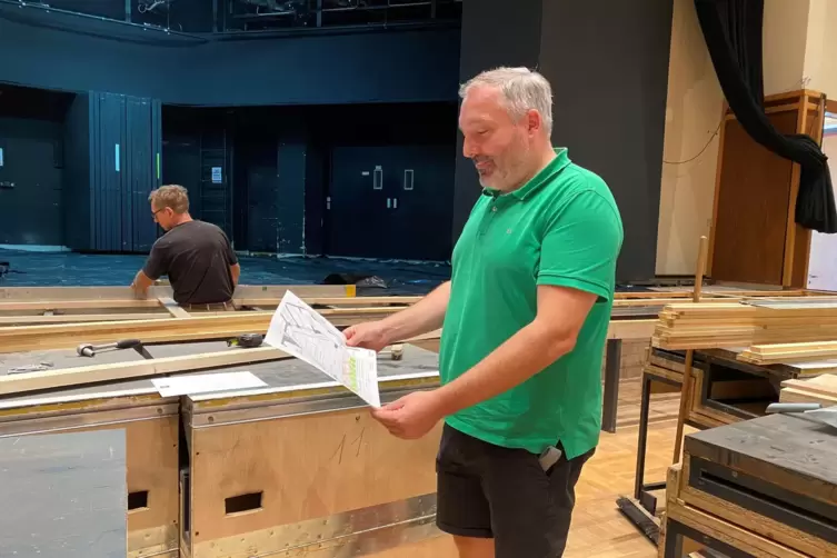 CCR-Geschäftsführer Andreas Guhmann wirft im großen Festsaal einen Blick auf die Pläne zum Neubau der Holzbühne. 