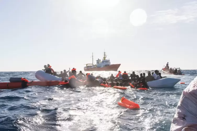 Mittelmeer: Flüchtlinge, die auf Booten von Libyen aus nach Italien übersetzen wollten, werden während eines Rettungseinsatzes v