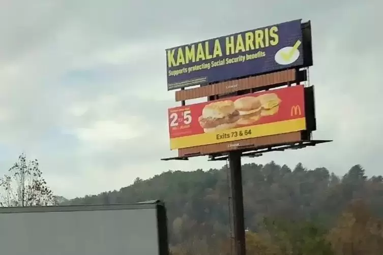 Harris-Werbung über McDonalds-Burger-Reklame. 