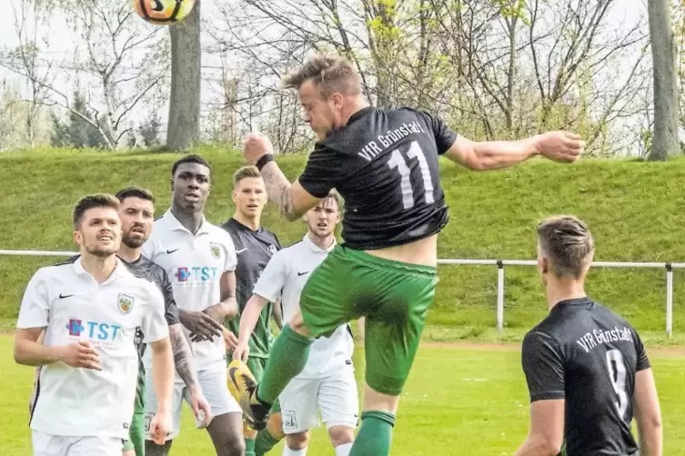 Tobias Fath (VfR Grünstadt) steigt zum Kopfball hoch: Mitspieler und Gegner beobachten mit Interesse die Aktion.