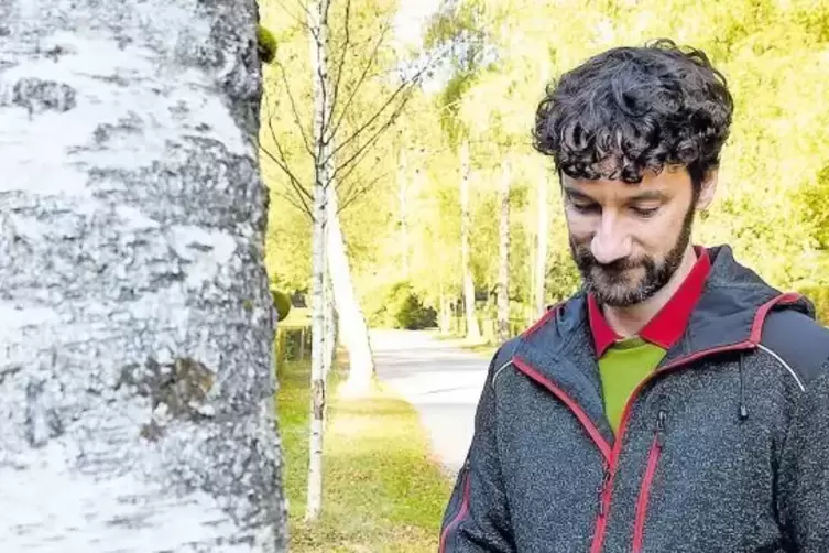 Gärtner Marc Schwartz kontrolliert die Bäume auf dem Waldfriedhof und vermerkt alles in einem EDV-Gerät.